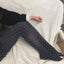 Eco friendly tights and socks - model wearing navy dotted tights, showcasing 50/80 denier recycled NilIt yarns for a sustainable look