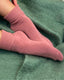 socks and accessories pink cozy socks on green blanket