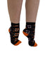 Black ankle socks with orange toe and heel featuring a pattern of smiling white and purple jack-o-lanterns fangs ankle socks sale