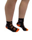 Black ankle socks with orange toe and heel accents and white purple smiling jack o lantern pattern fangs ankle socks sale