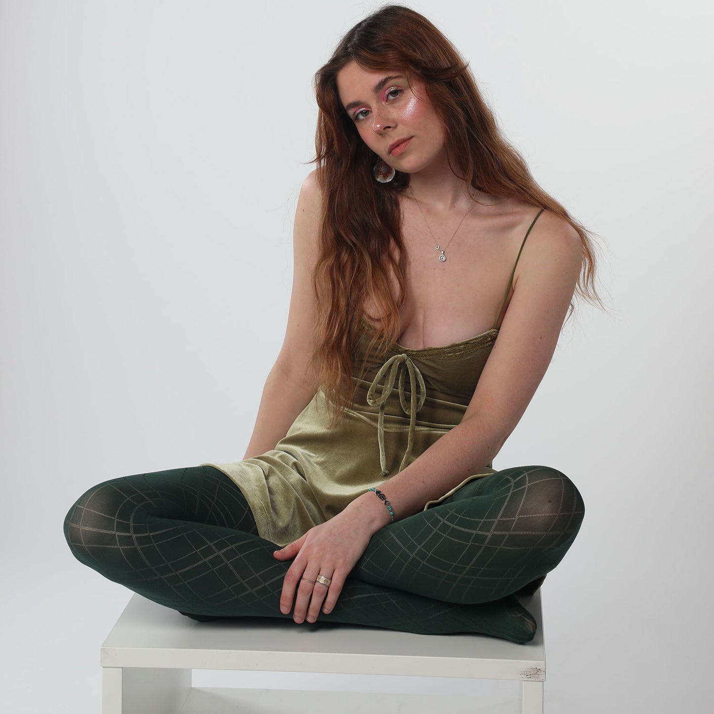 
                  
                    Model wearing Lattice Diamond pattern tights in green from better tights
                  
                